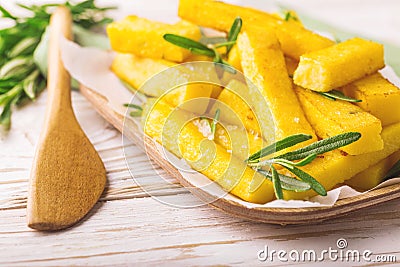 Polenta fries with rosemary. Italian appetizers. Horizontal view Stock Photo