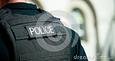 Police badge on black body armour vest. Editorial Stock Photo