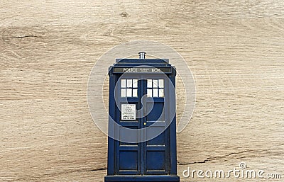 Police call box isolated on wooden background. Tardis from Doctor Who. Editorial Stock Photo