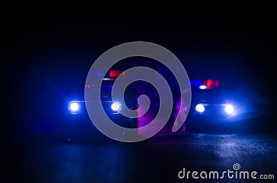 Police car chasing a car at night with fog background. 911 Emergency response police car speeding to scene of crime. Stock Photo