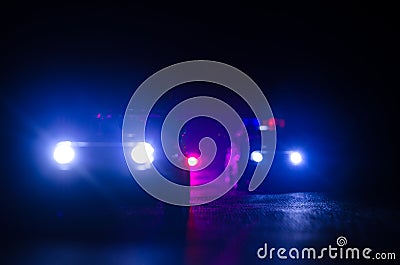 Police car chasing a car at night with fog background. 911 Emergency response police car speeding to scene of crime. Stock Photo