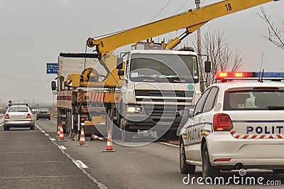 Police car and crane at crash site Stock Photo