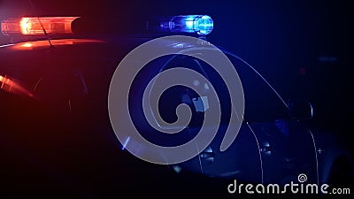 Police car driving into urgent call with flashing lights, protection of order Stock Photo