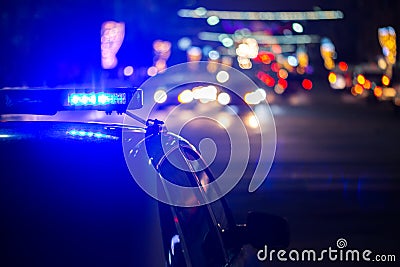 Police car lights at night in city with selective focus and bokeh Stock Photo