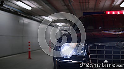 Police car parked at parking at night. Lights flashing on patrol vehicle Stock Photo