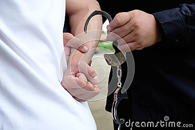 Police control violence in protest, arrest and suppress violence Handcuffing the accused Promoter Stock Photo