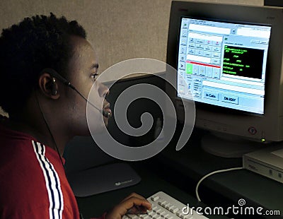 Police dispatcher using a computer to dispatch units to calls for help Editorial Stock Photo