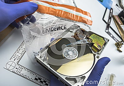 Police expert examines hard drive in search of evidence Stock Photo