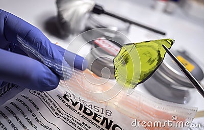 Police expert gets blood sample from glass bottle in Criminalistic Lab Stock Photo