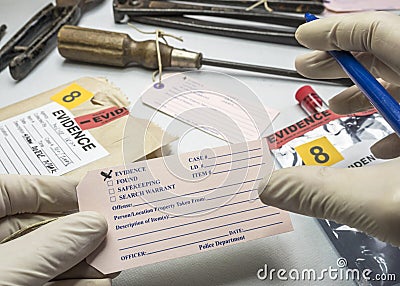 Police expert writes about label evidence number, Various laboratory tests forensic equipment Stock Photo