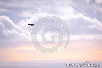 Police helicopter in clouds Stock Photo