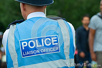 Police liaison officer monitoring demonstration protesters. Editorial Stock Photo