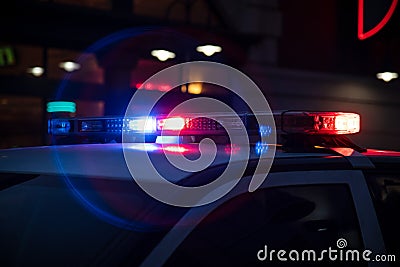 Police Lights Flashing on Dark Street Stock Photo