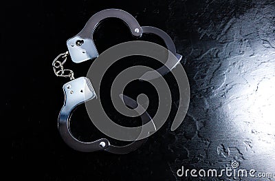 Police metal real handcuffs on the black background. Crime and robbery, prison concept Stock Photo