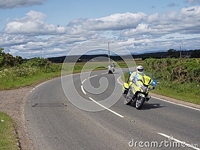 A Police Motorbike on a Country Road near to Friockheim in Angus as part of the Brechin Harley Davidson in the City Meet. Editorial Stock Photo
