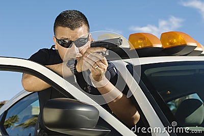 Police Officer Aiming Handgun Stock Photo