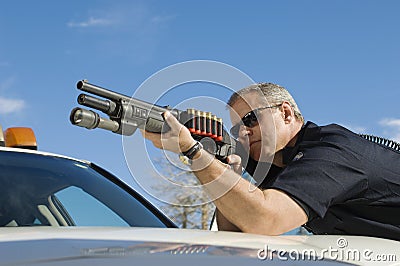 Police Officer Aiming Shotgun Stock Photo