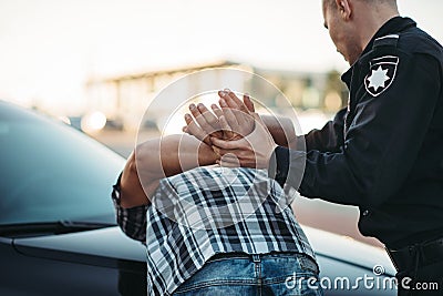 Police officer arrests the driver violator on road Stock Photo