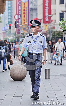 Police officer in city center, Shanghai, China Editorial Stock Photo