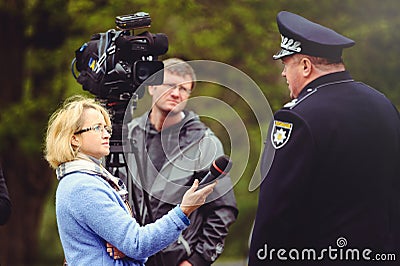 Police officer gives an interview Editorial Stock Photo