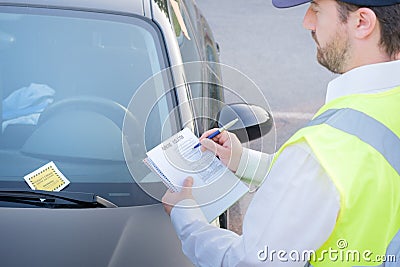 Police officer giving a fine for parking violation Stock Photo