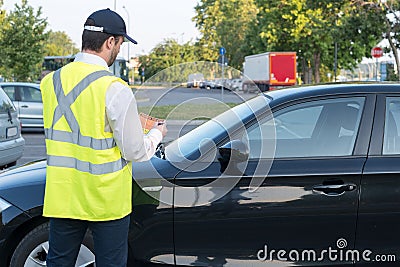 Police officer giving a fine for parking violation Stock Photo