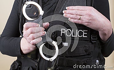 Police officer holding hand cuffs Stock Photo