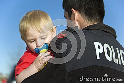 Police Officer Holds Baby Stock Photo