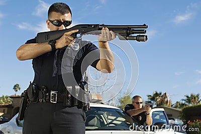 Police Officer With Shotgun Stock Photo