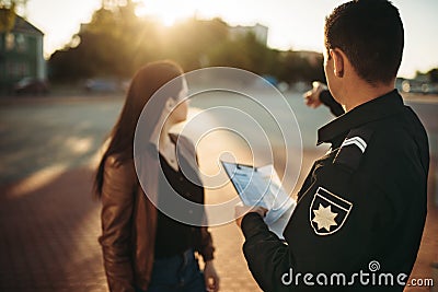 Police officer shows parking place to driver Stock Photo