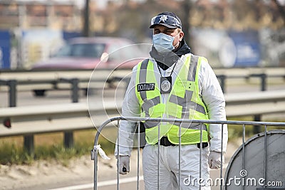 Police officer standing at a checkpoint during coronavirus disease COVID-19 outbreak in Kyiv, Ukraine April 18, 2020 Editorial Stock Photo