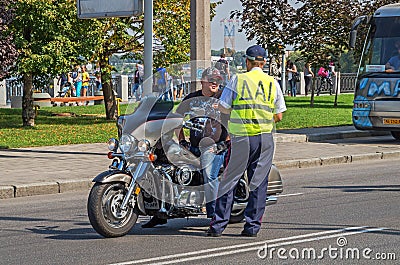 Police officer stops biker for violating traffic rules Editorial Stock Photo