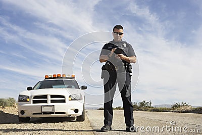 Police Officer Taking Notes In Front Of Car Stock Photo