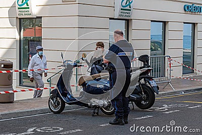 A police officer writes a fine to two misplaced scooters Editorial Stock Photo