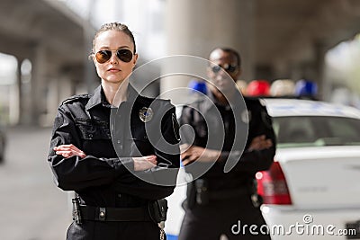 police officers with crossed arms looking at camera in front Stock Photo