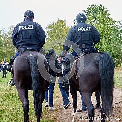 Police officers on horseback riding at the end of a demonstration march Editorial Stock Photo