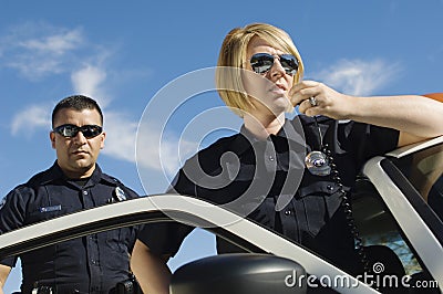 Police Officers Using Two-Way Radio Stock Photo