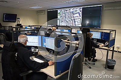 Police officers at surveillance control center room wide Editorial Stock Photo