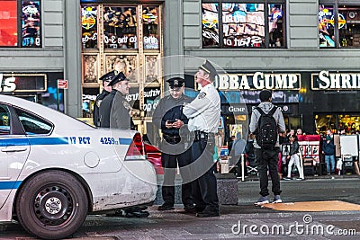 Police pays attention at times square by night Editorial Stock Photo