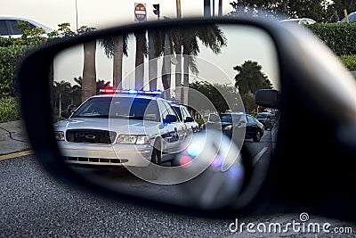 Police on rear view mirror Stock Photo