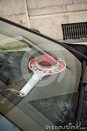 Police stop sign inside unmarked car Stock Photo