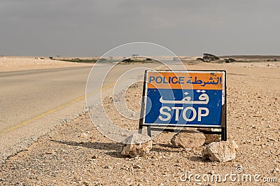 Police stop sign in desert road Stock Photo