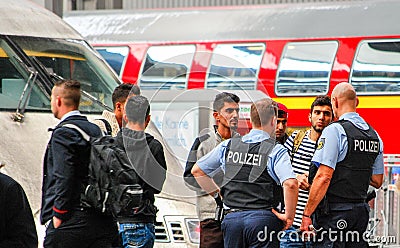 Police talk to several migrants that arrived by train Editorial Stock Photo