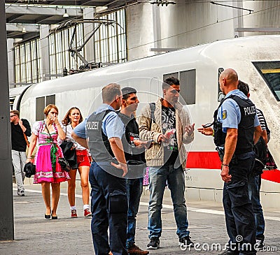 Police talk to several migrants that arrived by train Editorial Stock Photo