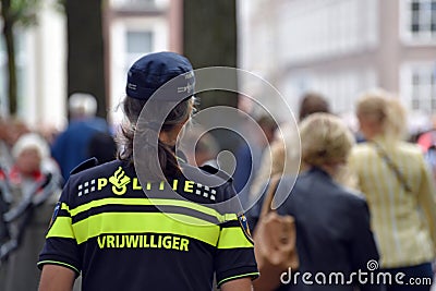 Police volunteer is watching the crowd Editorial Stock Photo