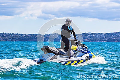 Police water patrol on a jetski during the 36th Americas Cup in Auckland, New Zealand Editorial Stock Photo
