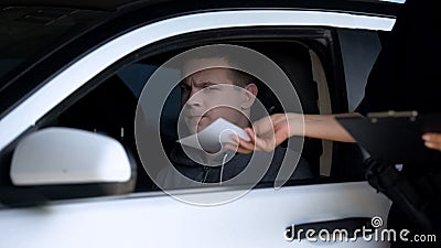 Police woman giving fine receipt to driver on road, traffic offence, inspection Stock Photo