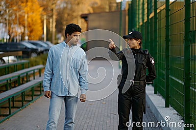 Police woman showing way to man passerby Stock Photo