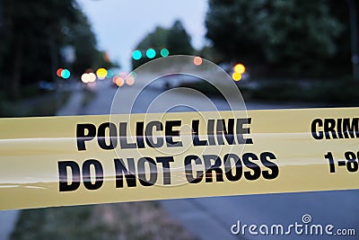 Police yellow line, blurred lights and traffic accident in background Stock Photo