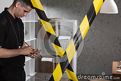 Policeman and barricade tape Stock Photo